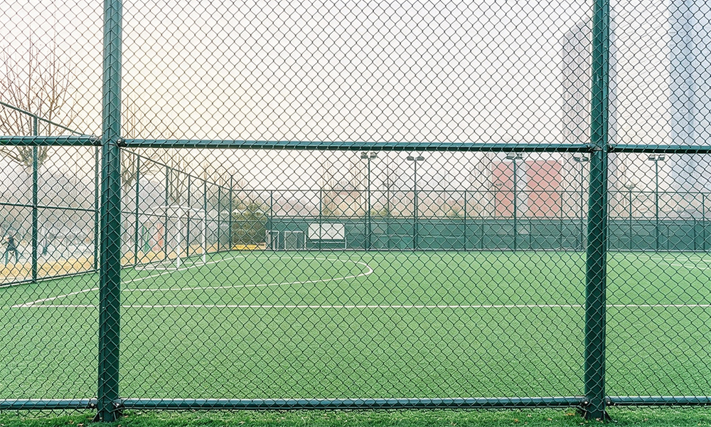 Sports field PVC chain link fence installation.jpg